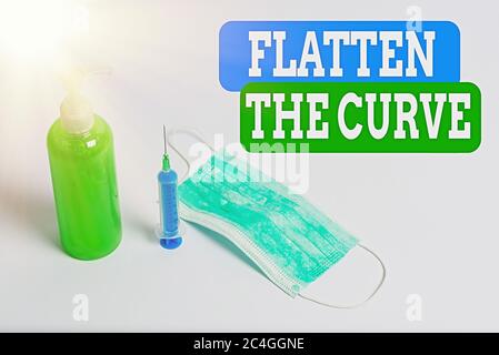 Writing note showing Flatten The Curve. Business concept for raising an awareness on slowing the rate of the infectious disease Primary medical precau Stock Photo