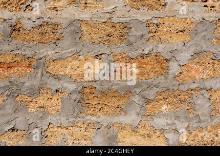 Wild stone shell rock wall texture. Decoration of external walls with bricks from wild stone shell rock. Uneven surface of shell rock Stock Photo