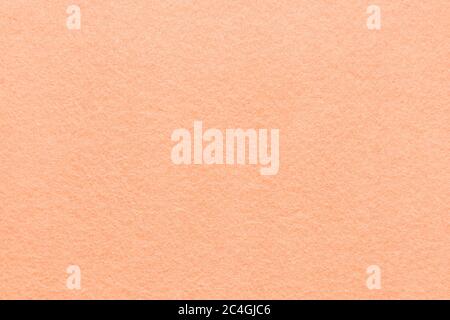 High resolution close up of bright peach felt fabric texture of rough fleecy fabric of peach color for backgrounds and for wallpaper an intense peach Stock Photo