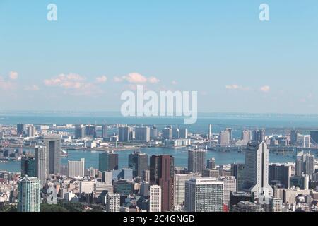 Tokyo's skyline seen from Skydeck at the top of the 238m Roppongi Hills Mori Tower. Tokyo Bay is in the background. Stock Photo
