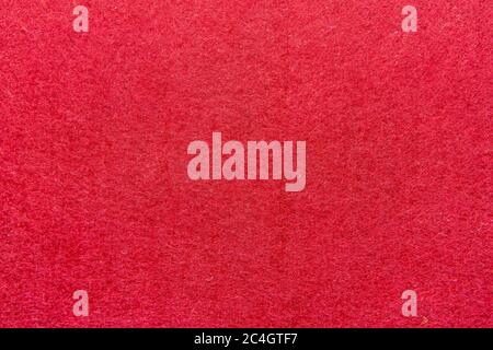 High resolution close up of bright red felt fabric texture of rough fleecy fabric of red color for backgrounds and for wallpaper an intense red piece Stock Photo