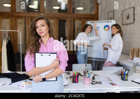 Young pretty stylish woman in striped shirt and denim skirt lean Stock Photo