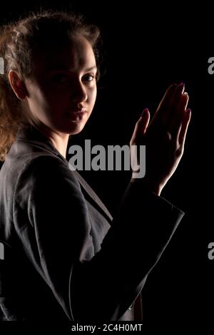 female's hand on a dark background, showing her palm Stock Photo