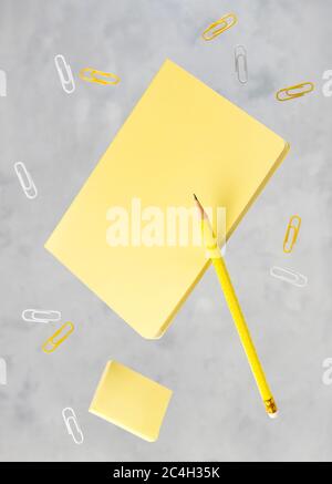 Office supplies stationery levitate over concrete gray background Stock Photo