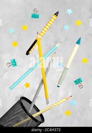 Office supplies stationery levitate over concrete gray background Stock Photo