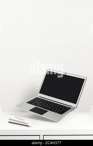Office supplies stationery levitate over white table Stock Photo