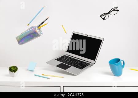 Office supplies stationery levitate over white table Stock Photo