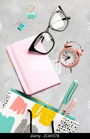 Office supplies stationery levitate over concrete gray background Stock Photo