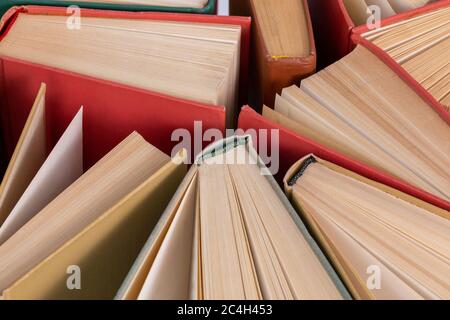 Many different old hardcover physical books close-up background with selective focus and blur Stock Photo