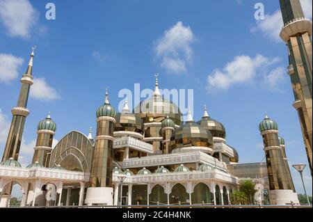 The Crystal Mosque (Masjid Kristal) in Kuala Terengganu, Malaysia. Golden minarets sparkle in the sun against a blue sky background Stock Photo