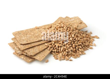 Stack of  crispbread and wheat grains isolated on white Stock Photo