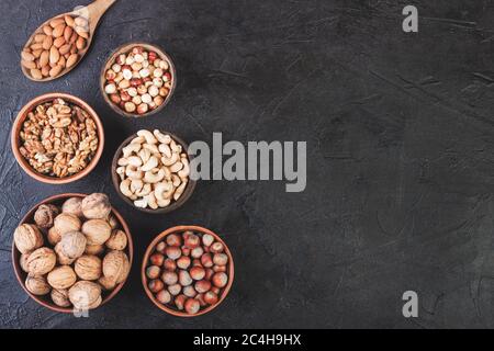 Different nuts in dishes, walnuts, hazelnuts, cashews and almonds Stock Photo