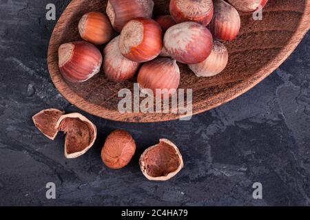 Hazelnuts in a spoon and one broken nut Stock Photo
