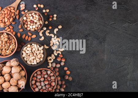 Different nuts in dishes, walnuts, hazelnuts, cashews and almonds Stock Photo