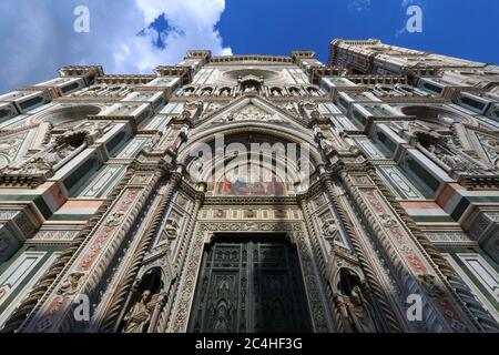 Santa Maria in Fiore facade with Giotto bell tower, wide angle shot from below in the sky, Florence, Italy, word heritage touristic site