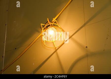 Close-up of work light and cabling in building under construction Stock Photo