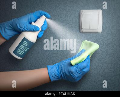 Disinfecting light switch to prevent coronavirus infection. House cleaning during a pandemic. Stock Photo