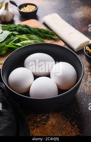 Chicken white eggs in black bowl side view Stock Photo