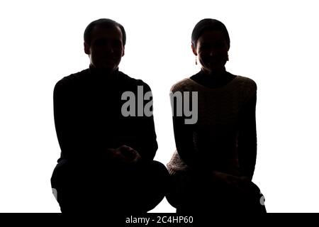 Portrait women and men across from, brother and sister squatted down - horizontal silhouette Stock Photo