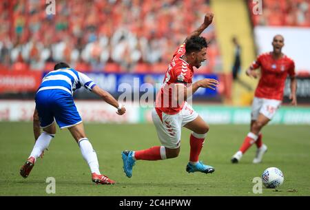 Charlton Athletic's Macauley Bonne (right) goes down under the challenge from Queens Park Rangers' Geoff Cameron (left) during the Sky Bet Championship match at The Valley, London. Stock Photo