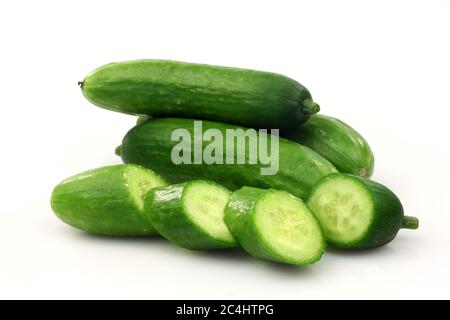 fresh green cut baby cucumbers you can eat as a snack on a white background Stock Photo