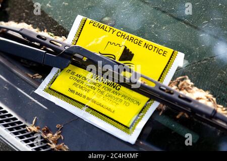 Parking ticket behind a windshield wiper in Tower Hamlets, London, UK Stock Photo