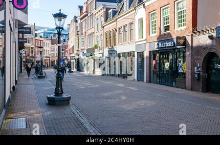 View of a desolate Utrecht city center with closed shops at the Steenweg. The streets are deserted due to the Corona pandemic. The Netherlands. Stock Photo