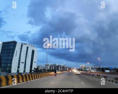 Storm monsoon clouds over a highway at dusk Stock Photo