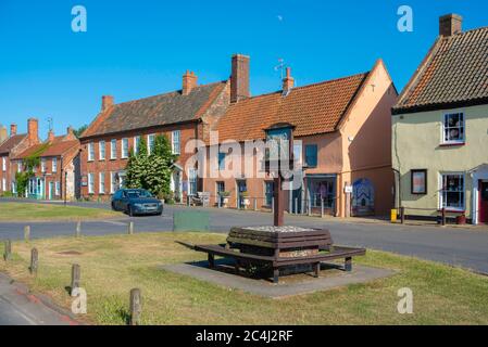 Burnham Market Norfolk, view in summer of the sign on the village green and traditional shops and property in Burnham Market, north Norfolk, UK Stock Photo