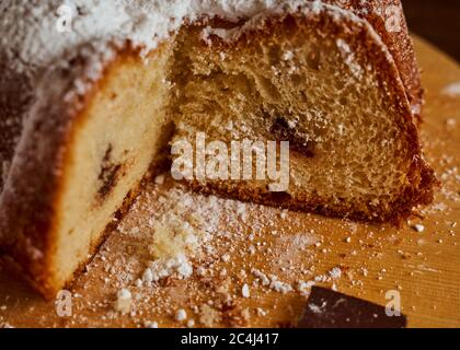 Cut homemade cupcake with chocolate cream inside on a wooden board. Close-up. Stock Photo