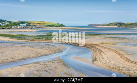 Twisting waters at low tide on the Camel Estuary in summer looking down towards Padstow, Cornwall. Beautiful sand, blue sea, sky and rural surrounds. Stock Photo