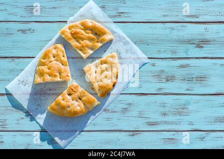 Genoese focaccia flatbread with with rosemary, extra virgin olive oil and salt . Stock Photo