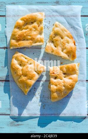 Genoese focaccia flatbread with with rosemary, extra virgin olive oil and salt . Stock Photo