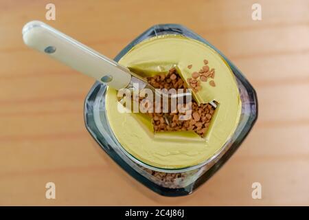 Close-up, shallow focus of instant, dried coffee granules seen in a plastic coffee jar. The freshness seal has been broken, letting the aroma out. Stock Photo