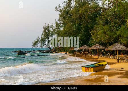 A beautiful beach with umbrellas, beach chairs and boats at the Long Set Beach, Koh Rong, Cambodia Stock Photo