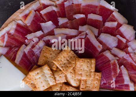 Wood plate with freshly ham, cheese and roasted bread. Healthy food. Spanish food. Stock Photo