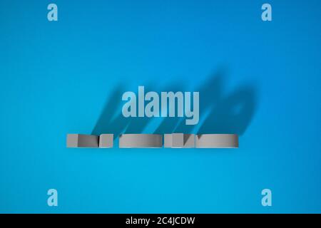 Words on a blue background. VOTE blocks and shadows. Stock Photo