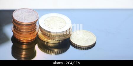 Stacks of coins reminding column diagram going down, Finance and banking loss concept. Copy space for text Stock Photo