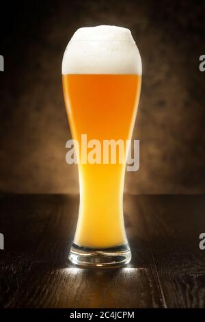 beer glass over a wooden table isolated on dark background Stock Photo