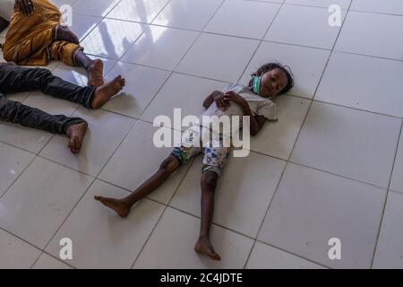 Lhokseumawe, Indonesia. 27th June, 2020. A migrant child rests at a temporary shelter in the immigration detention centre.Dozens of Rohingya people were rescued at sea by Indonesian fishermen while drifting on a broken boat in waters off Seunuddon in North Aceh. Credit: SOPA Images Limited/Alamy Live News Stock Photo