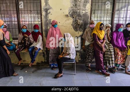 Lhokseumawe, Indonesia. 27th June, 2020. Migrant women look on at a temporary shelter in the immigration detention centre.Dozens of Rohingya people were rescued at sea by Indonesian fishermen while drifting on a broken boat in waters off Seunuddon in North Aceh. Credit: SOPA Images Limited/Alamy Live News Stock Photo