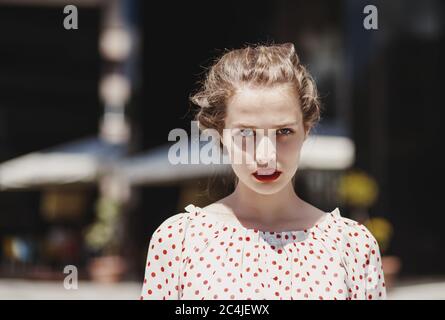 Portrait of young woman in polka dot blouse Stock Photo