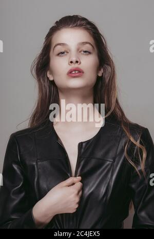 Fashion portrait of a young woman wearing leather jacket Stock Photo