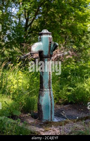 Old rusty drinking water fountain in Vallisaari, former military island, now a day trip destination in Helsinki archipelago, Finland Stock Photo