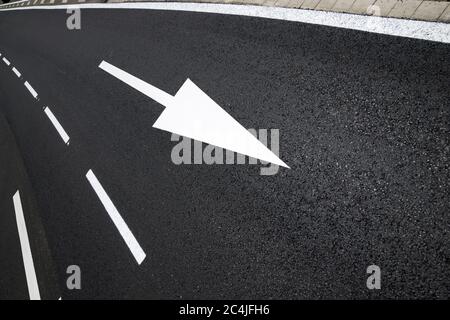 Arrow directional signal painted on the floor in Spain Stock Photo