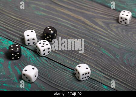 Dices are white and black. On brushed pine boards. Stock Photo