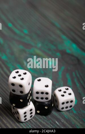 Dices are white and black. On brushed pine boards. Stock Photo