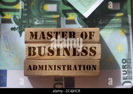 Master of Business Administration on Wooden blocks. put on 100 Euro banknotes. MBA business education concept Stock Photo