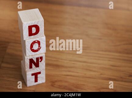 Don't words on wooden blocks arrange vertically with copyspace for motivational concept Stock Photo