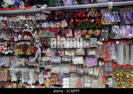 Christmas Market. Christmas Decoration Shelves Filled With Tree Ornaments, Shiny Baubles, Gift Stockings, Antler Headbands, Novelty Decorations, Signs Stock Photo